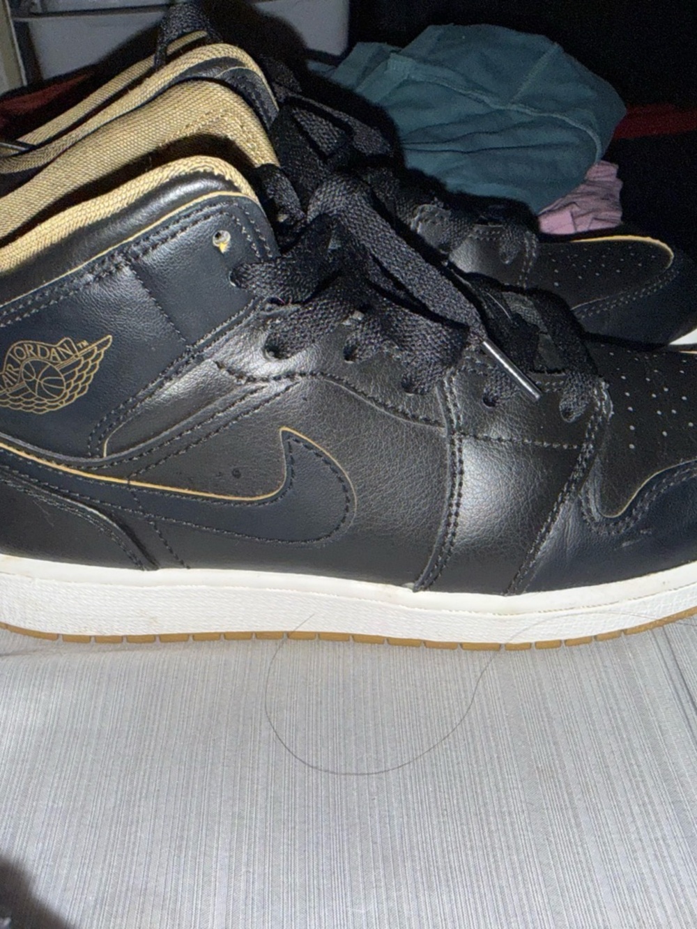 Nike Air Jordan 1 Mid shoes in the "Black Gold" or "Black/Metallic Gold/White